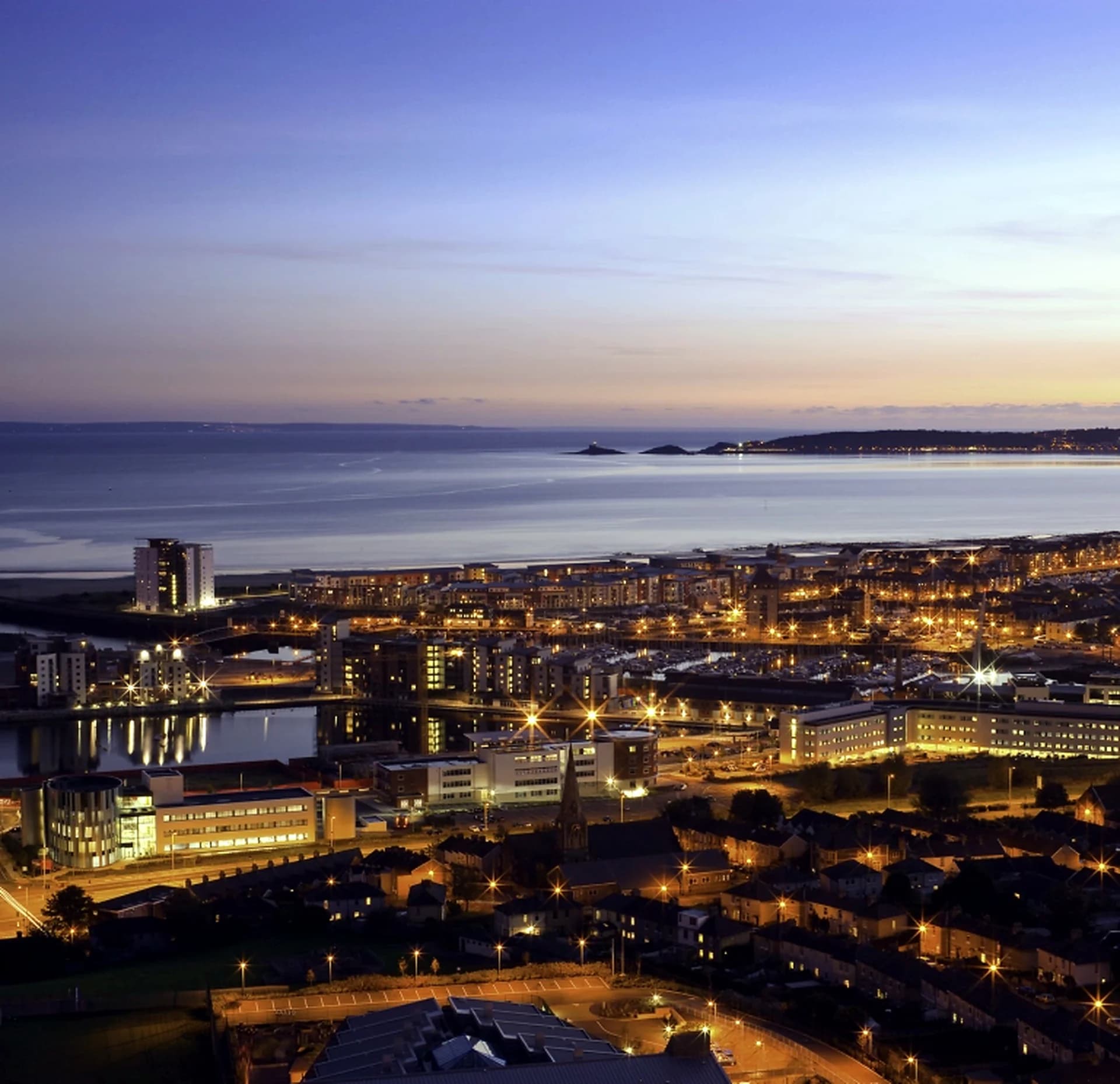 Swansea Bay and city lights at night viewed from above